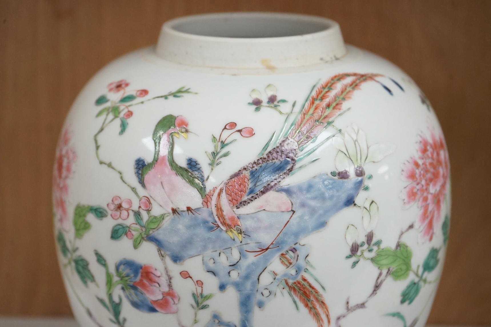 A late 19th century Chinese famille rose 'pheasant' jar lacking cover, with finely carved wooden stand, 21.5cm high including stand.